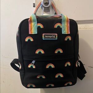 Lounge fly rainbow backpack. Jean style material with rainbows